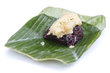Thai custard sticky black rice dessert on banana leaf isolated o