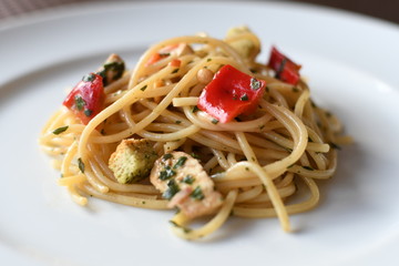 pasta salad with spaghetti, pepper, mozzarella, red onion, pine nuts