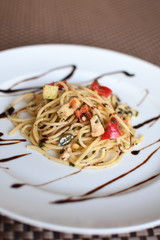 pasta salad with spaghetti, pepper, mozzarella, red onion, pine nuts