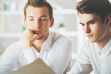 Handsome boys doing paperwork