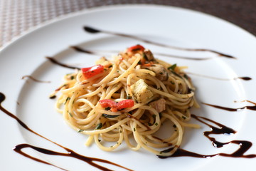 pasta salad with spaghetti, pepper, mozzarella, red onion, pine nuts