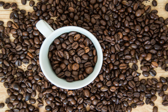 Roasted coffee beans with cup