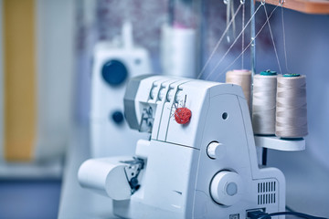 Seamstress inserts thread in old sewing machine