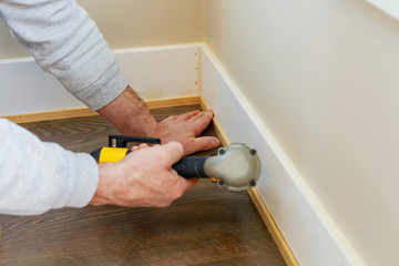 Gauge Finish Nailer man nailed slats custom house building contractor up a wall section for luxury