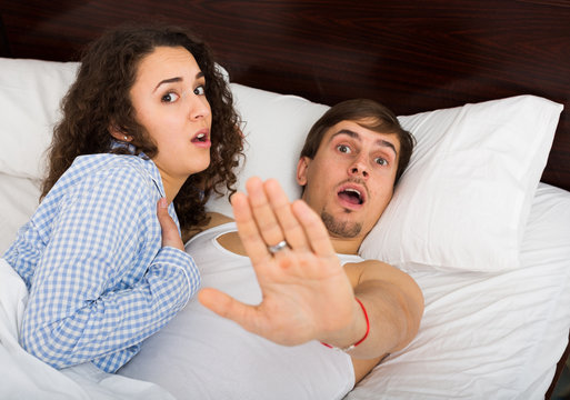 Young adults caught having sex in bed