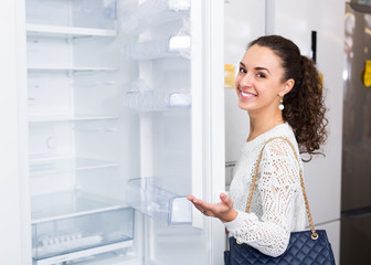 Fototapeta na wymiar brunette choosing new refrigerator