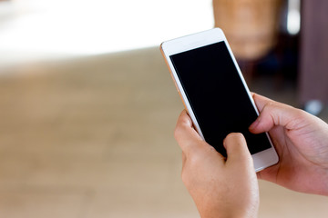 hand using cell phone with black screen