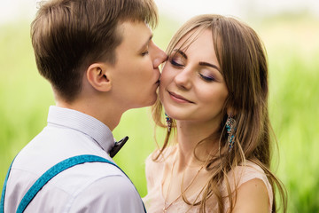 Wedding couple, beautiful newlyweds tenderly kissing at wedding ceremony