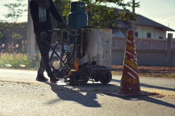 Asphalt road marking paints and striping with thermoplastic spray.