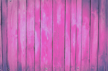 pink, violet old wooden fence. wood palisade background. planks texture