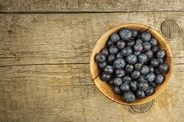 Fresh blueberries on old wooden table. Homework marmalade. Healthy forest fruit. Nutrition for athletes.