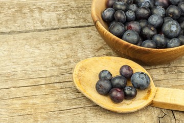 Fresh blueberries on old wooden table. Homework marmalade. Healthy forest fruit. Nutrition for athletes.