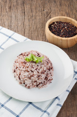 kitchen table with rice berry and rice grain on wood plate. thai local food, selective focus on top view.