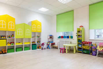 Interior of a modern kindergarten in yellow and green colors. - obrazy, fototapety, plakaty