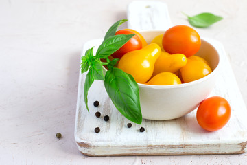 bowl with different cherry tomatoes and basil