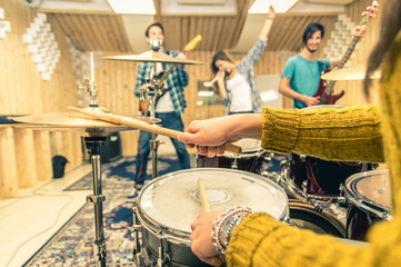 Young band music recording a song at the studio.