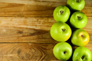 Green apples on a wooden table