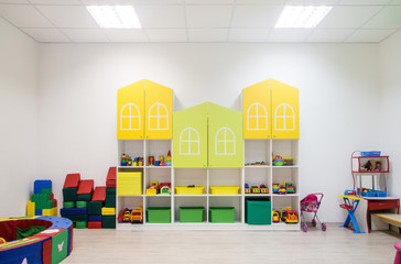 Bright Interior of a modern kindergarten in yellow and green colors.