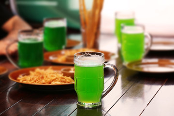 Mug with cold beer on table in pub