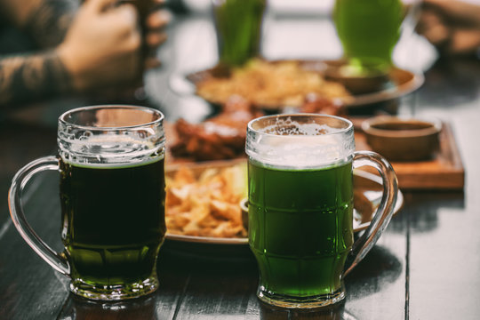 Mugs with cold beer on table in pub