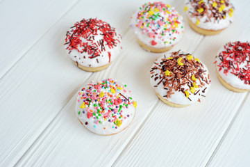 Cupcakes with white cream  and sprinkles on white background
