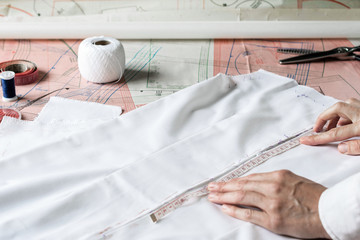 Seamstress is measuring needlework. Style and design development and creating garment, clothes sew...