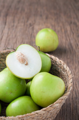 kitchen table with  slice fresh monkey apple on basket. 
