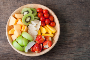 kitchen table with Variety of Fruits on wood plate, group of Fruits on plate.