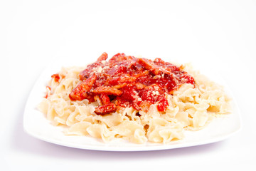 Tagliatelle mosse with tomato sauce with ham, sprinkled with parmesan