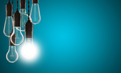 Idea and leadership concept - bulbs on the grunge background