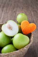 kitchen table with slice fresh monkey apple on basket.