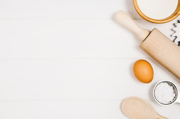 Baking a cake or pizza ingredients background. Top view photograph with kitchen utensils on vintage, natural, white, wooden background.