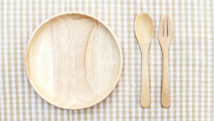 Wooden Plate, Fork and Spoon on table top view 2 