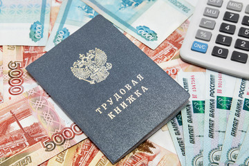 Work-book and calculator on the background of Russian money / Ru