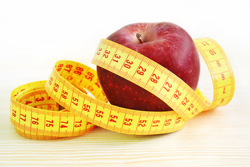red apple with tape measure - weight loss - diet concept