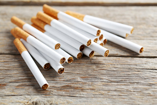 Tobacco cigarettes on a grey wooden table