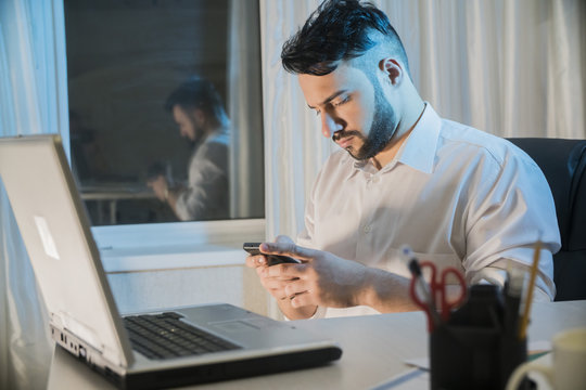 Male Freelance Sitting In An Office Behind A Computer Laptop Think And Dream