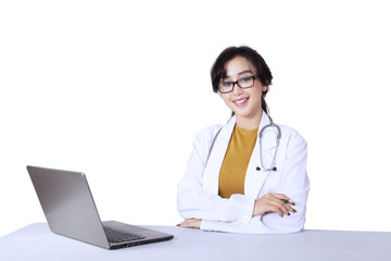 Female doctor sitting with laptop