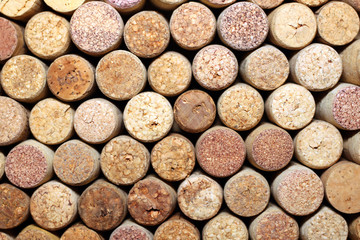 Background of used wine corks. Wall of many different wine corks. Closeup of wine corks.