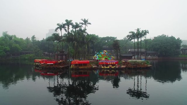 rafts with red roof in small island in pond in city park