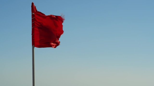 red flag at sea. Swimming is prohibited