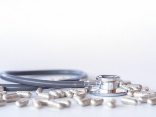 stethoscope and pills on white background. health care concept.