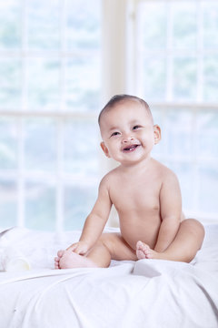 Nice baby laughing in the bedroom