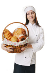 Female baker or saleswoman in her bakery selling fresh bread, pastries and bakery products in basket