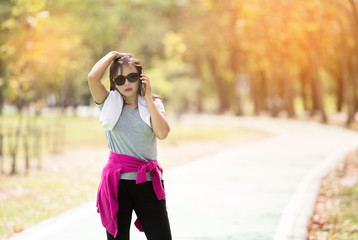 Asian executive mature woman runner taking a rest