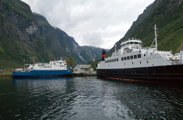 Two ferries at the pier of Norwegian fjord. Selective focus.