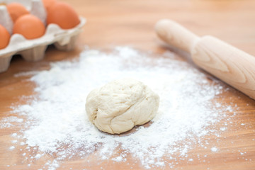 Ingredients for cooking baking - flour, egg, dough on wooden background.