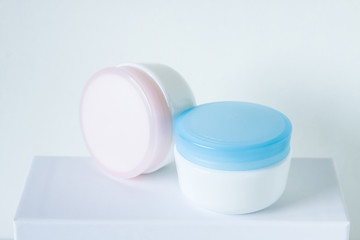 Cosmetic  jars mock up , for day and night face and skin care cream. Spa and beauty saloon motif wallpaper. 
