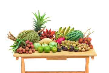 Fresh mixed fruits on wood table isolated on white background.