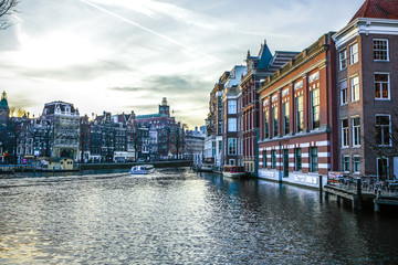 AMSTERDAM, NETHERLANDS - JANUARY 10, 2017: Famous vintage buildings & chanels of Amsterdam city at sun set. General landscape view. January 10, 2017 - Amsterdam - Netherlands..